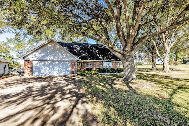 view of front facade with a garage and a front yard