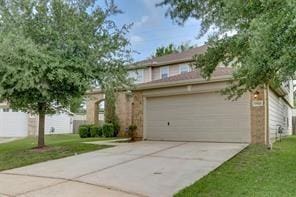 view of front facade with a garage and a front lawn