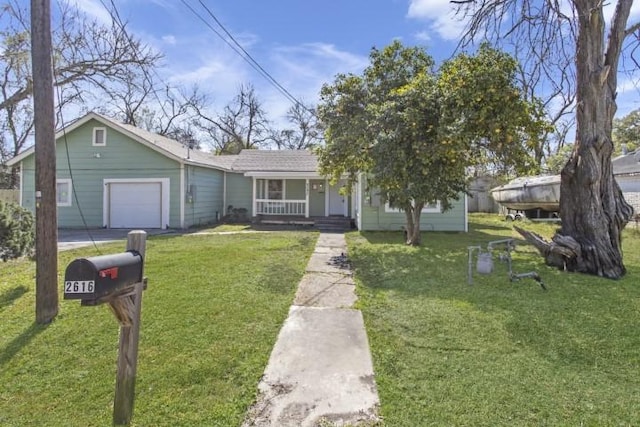 view of front facade with covered porch, a garage, and a front yard