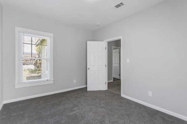 unfurnished bedroom with dark carpet