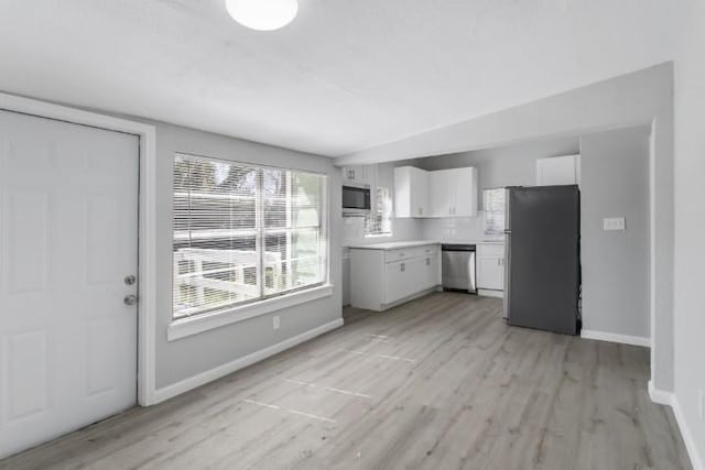 kitchen featuring white cabinetry, stainless steel appliances, and light hardwood / wood-style floors