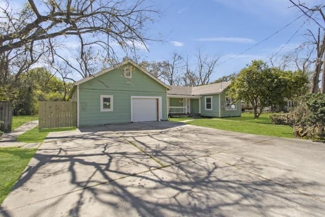 view of front of property with a front yard and a garage