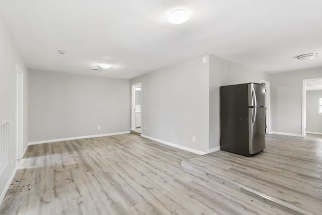 unfurnished room with light hardwood / wood-style floors