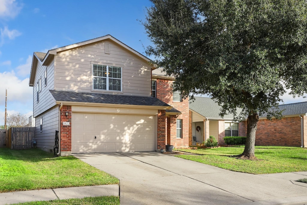 view of front property featuring a garage and a front lawn