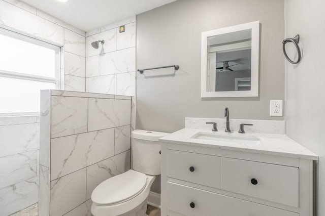 bathroom featuring vanity, toilet, and a shower