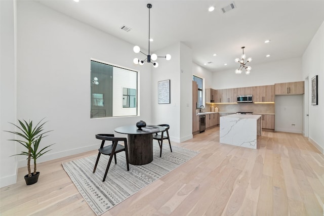 kitchen with pendant lighting, a center island, light stone countertops, and appliances with stainless steel finishes