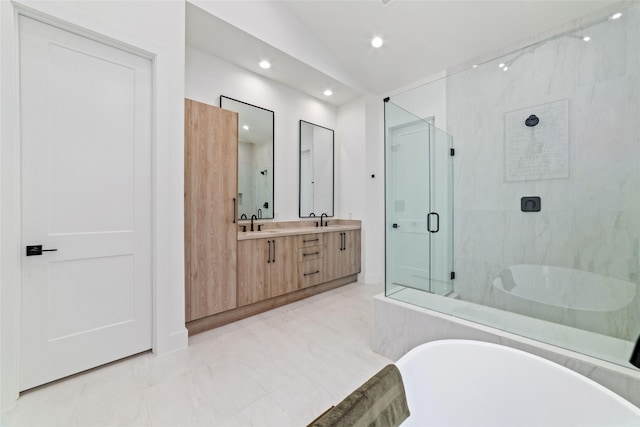 bathroom featuring vanity, vaulted ceiling, and independent shower and bath