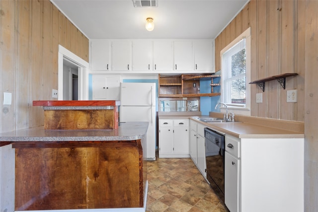 kitchen featuring white cabinetry, wooden walls, and white refrigerator