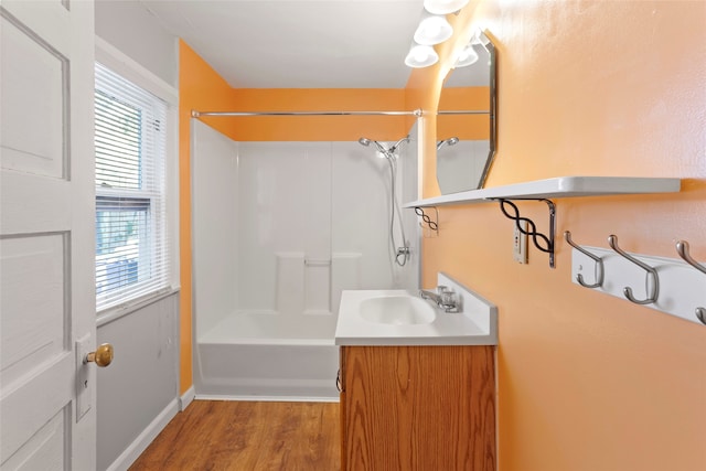 bathroom with shower / bath combination, vanity, and wood-type flooring