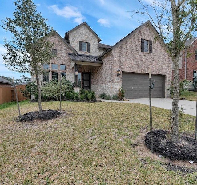 view of front of home featuring a garage and a front lawn