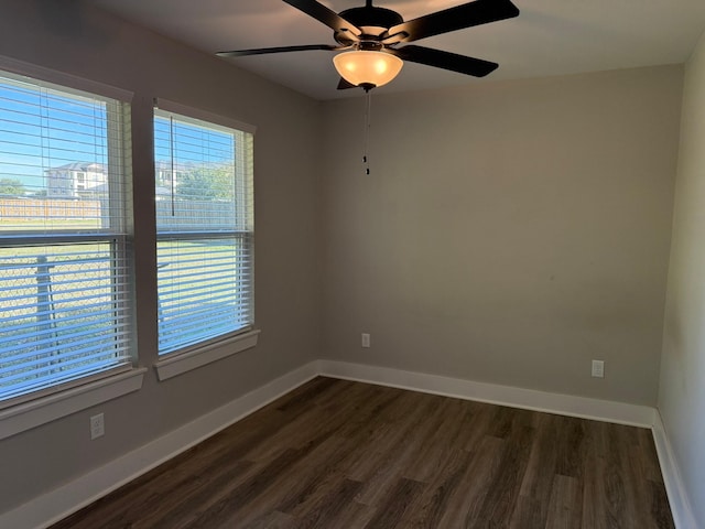 empty room with ceiling fan and dark wood-type flooring