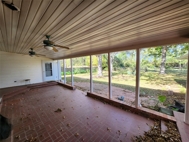 unfurnished sunroom with ceiling fan, wooden ceiling, and lofted ceiling