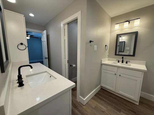 bathroom with hardwood / wood-style flooring, vanity, and ceiling fan