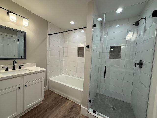 bathroom featuring hardwood / wood-style flooring, vanity, and independent shower and bath