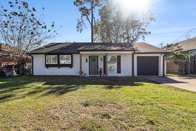 ranch-style home featuring a garage and a front yard