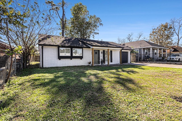 single story home with a front yard and a garage