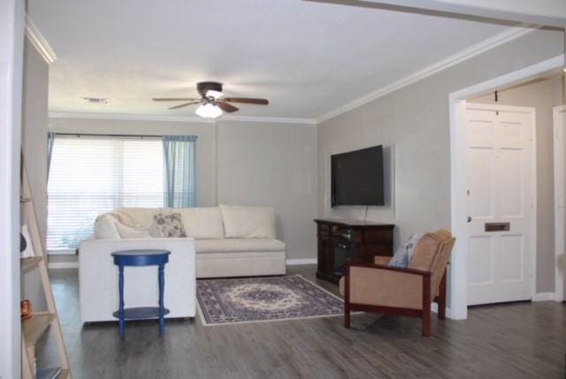 living room with ceiling fan, dark hardwood / wood-style flooring, and ornamental molding