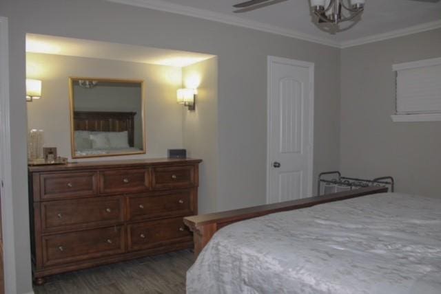 bedroom featuring crown molding and dark hardwood / wood-style floors