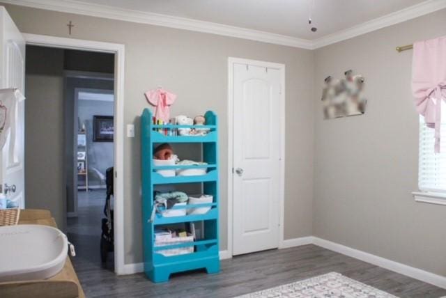 bedroom featuring crown molding and dark hardwood / wood-style flooring