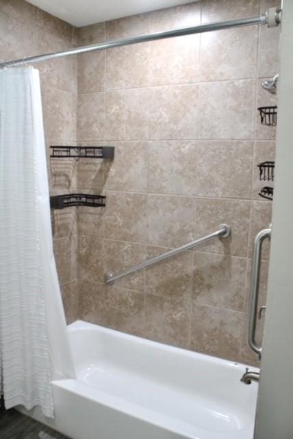 bathroom with shower / bathtub combination with curtain and hardwood / wood-style flooring