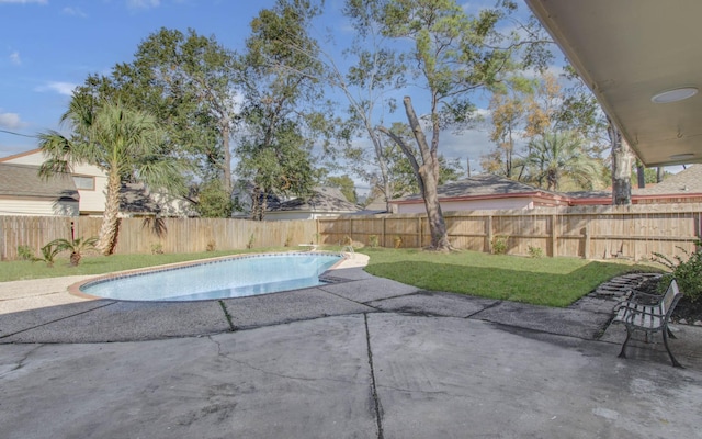 view of pool featuring a yard and a patio