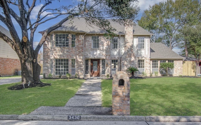 colonial-style house with a front lawn