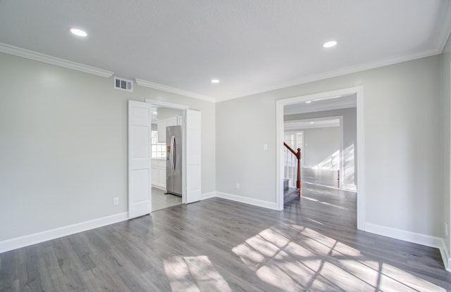 spare room with dark hardwood / wood-style floors and ornamental molding