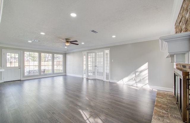 unfurnished living room with crown molding, ceiling fan, a textured ceiling, a fireplace, and dark hardwood / wood-style flooring