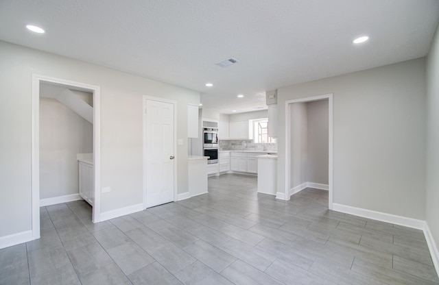 unfurnished living room featuring light hardwood / wood-style floors