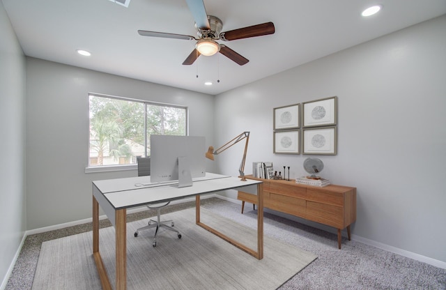 carpeted home office with ceiling fan