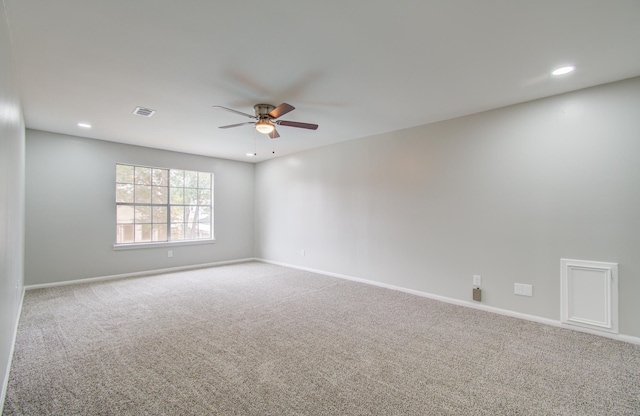 unfurnished room featuring ceiling fan and carpet