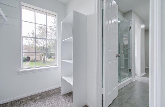 bathroom with tile patterned flooring and a shower with shower door