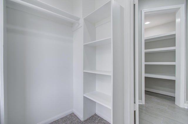 walk in closet with light wood-type flooring