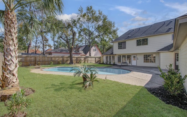 view of pool featuring a lawn and a patio