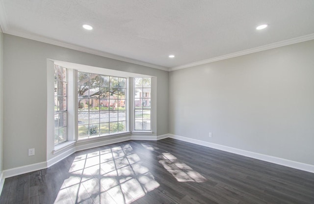 spare room featuring a textured ceiling, dark hardwood / wood-style floors, and ornamental molding