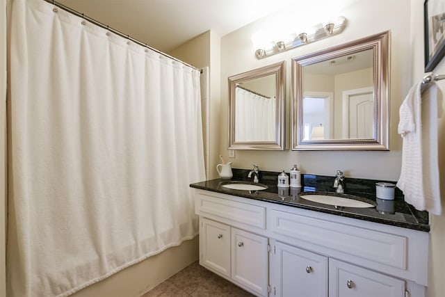 bathroom featuring tile patterned flooring, vanity, and shower / bath combo