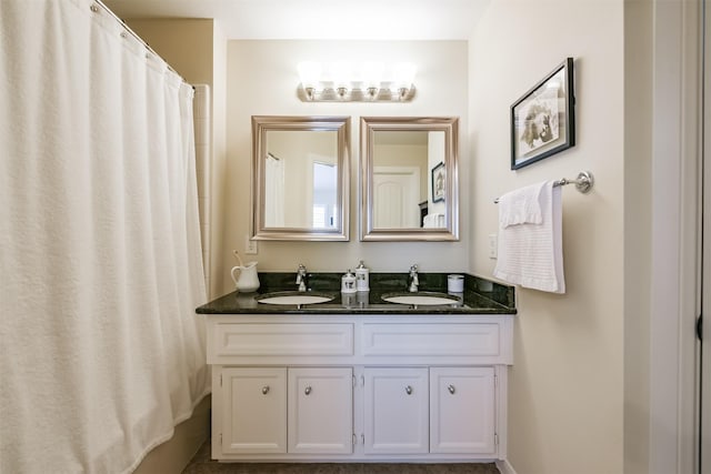 bathroom featuring vanity and curtained shower