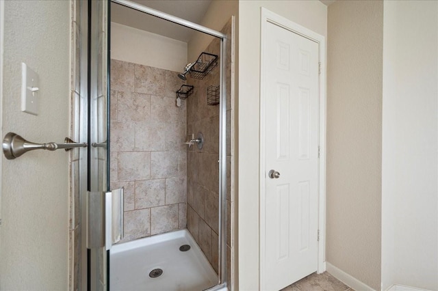 bathroom featuring a shower with door