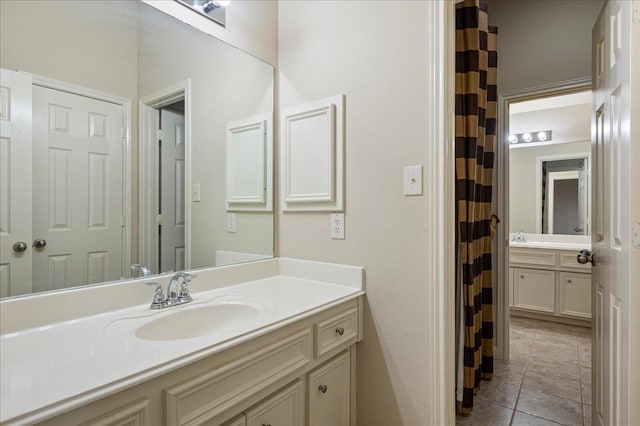 bathroom with tile patterned flooring and vanity