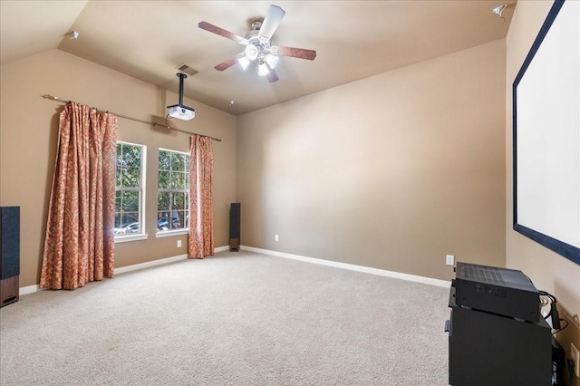 carpeted home theater room featuring ceiling fan and lofted ceiling