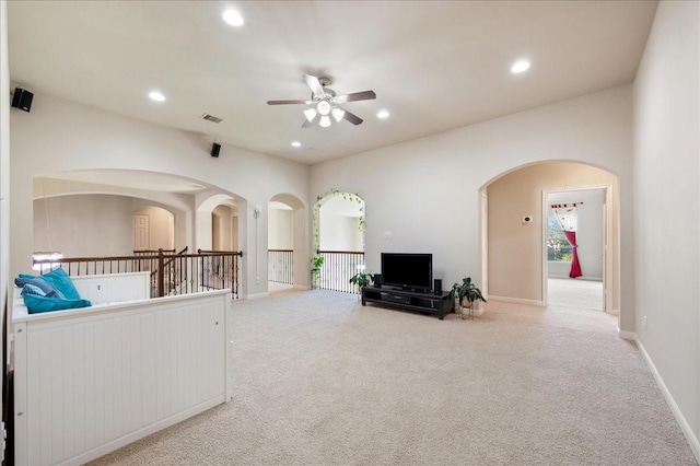 carpeted living room featuring ceiling fan