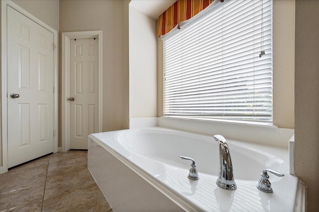 bathroom featuring a tub to relax in and tile patterned flooring