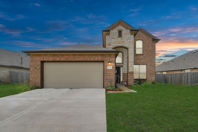 view of front of property with a yard and a garage