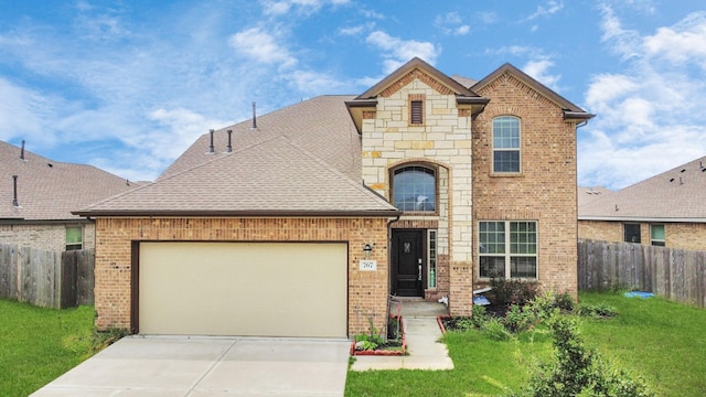 view of property featuring a garage and a front lawn