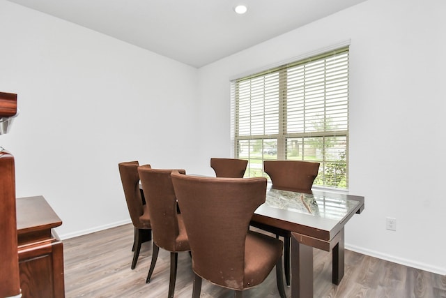 dining space with hardwood / wood-style floors