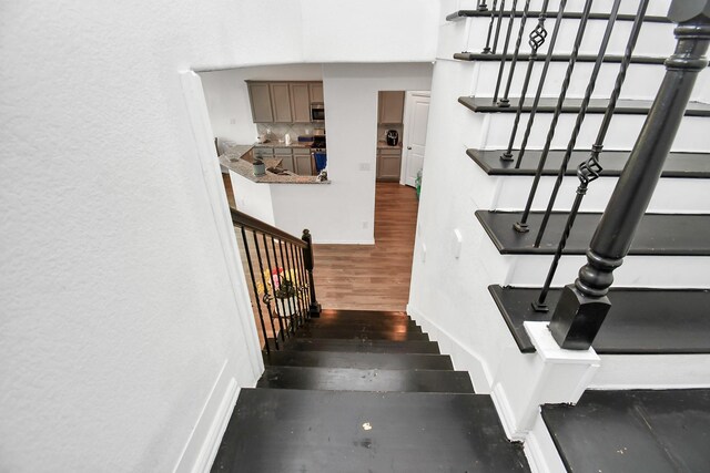 staircase featuring hardwood / wood-style flooring