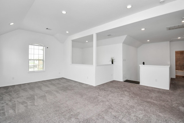 unfurnished room with carpet floors and lofted ceiling