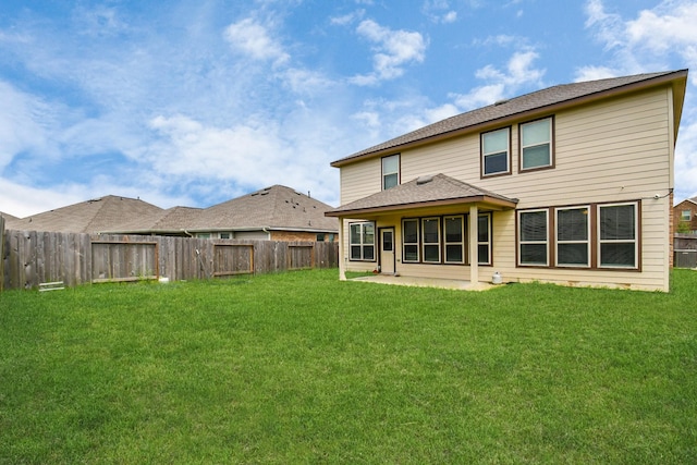 rear view of house with a lawn and a patio area