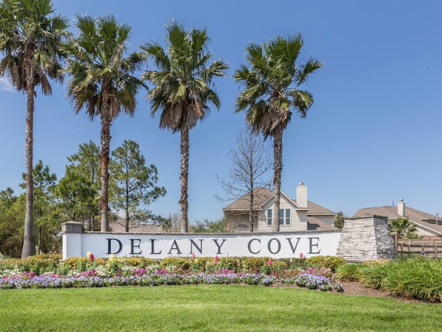 community / neighborhood sign with a lawn