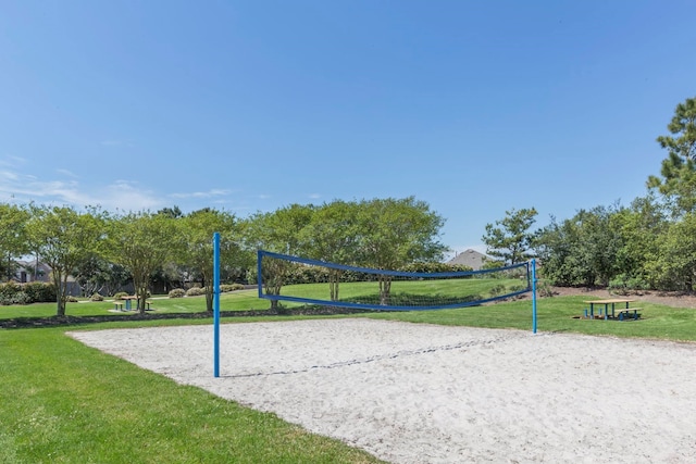 view of community featuring volleyball court and a lawn